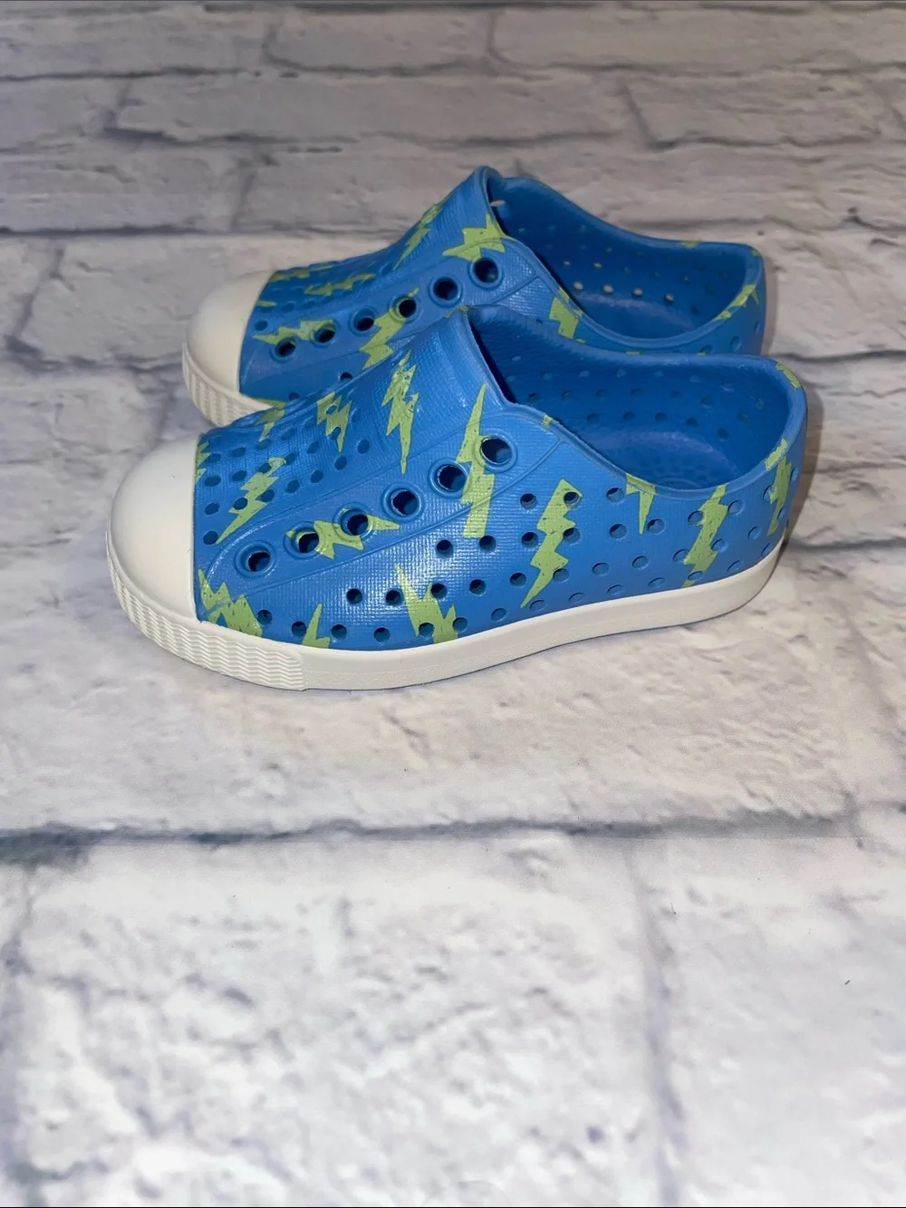Native Jefferson Blue Slip-On with Neon Lightning Bolts. Size 5